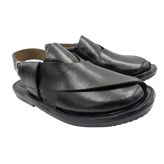 Pair of black leather sandals on a white background