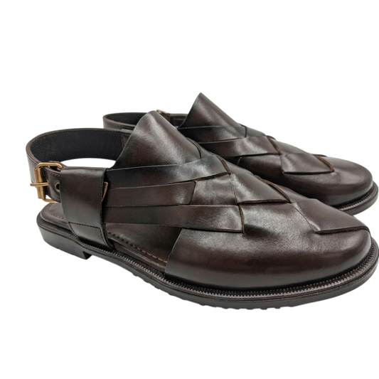 Pair of brown woven sandals on a white background