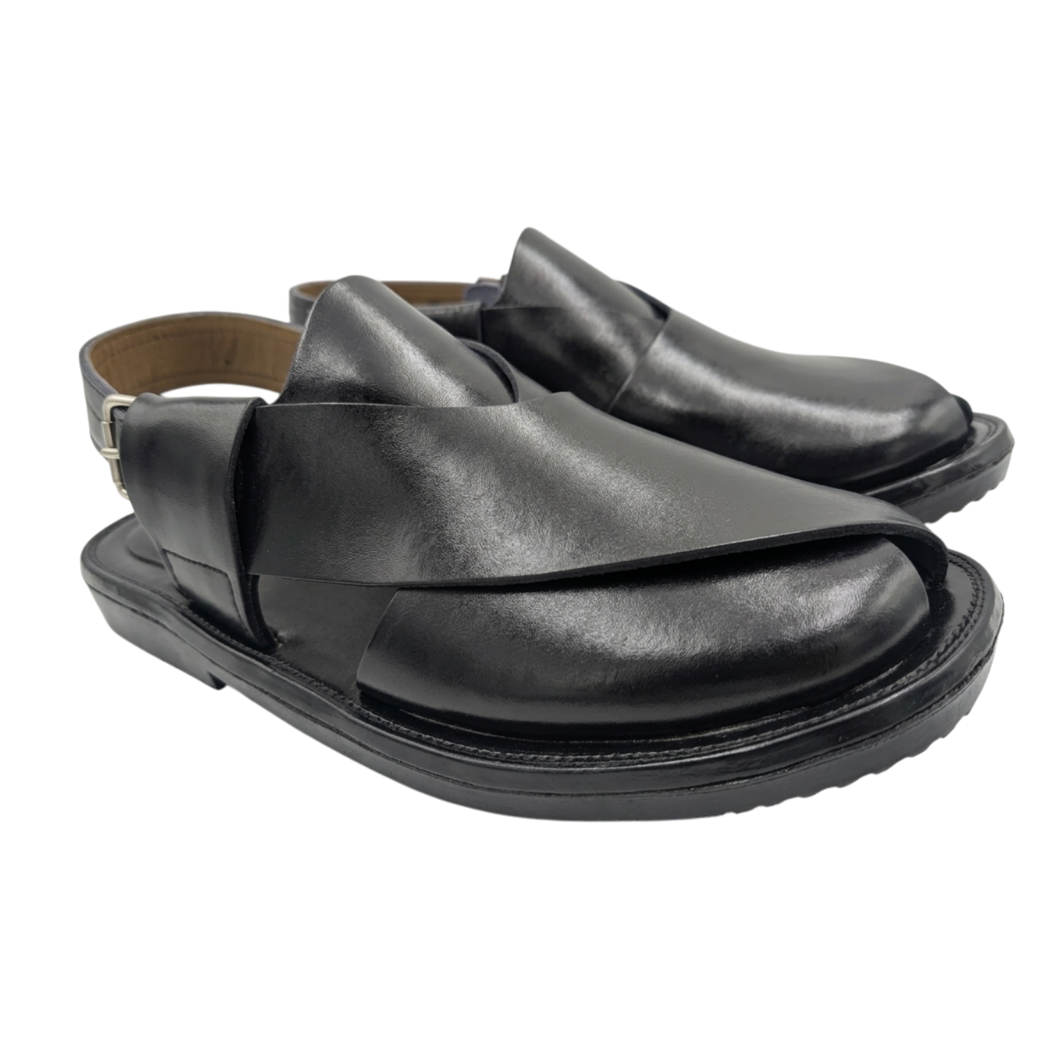 Pair of black leather sandals on a white background